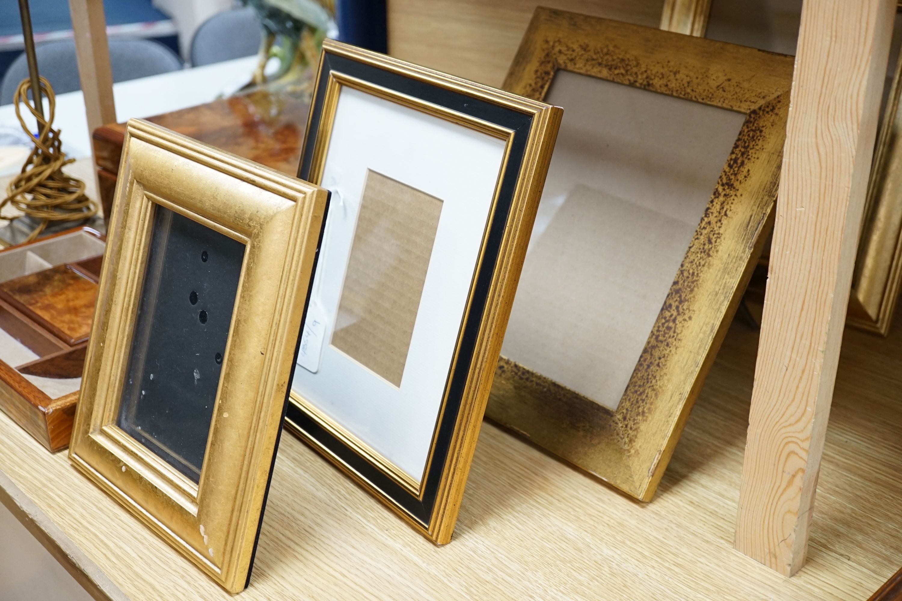 A burr walnut jewellery box, collection of gilt photo frames and a pair of table lamps